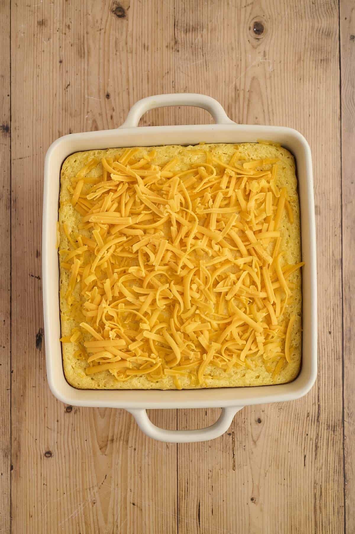 Cheese topped corn casserole, ready to melt.