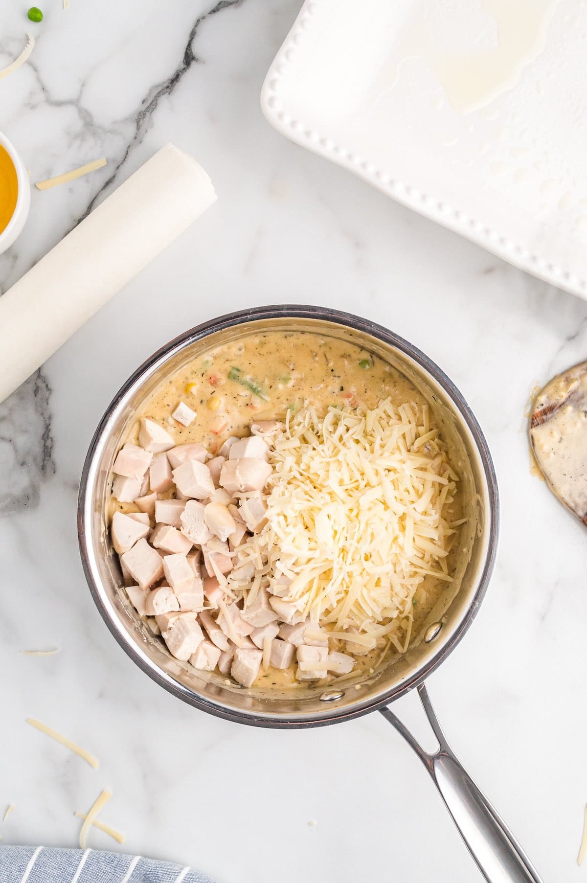 Diced chicken and shredded cheese added to a pot pie sauce.