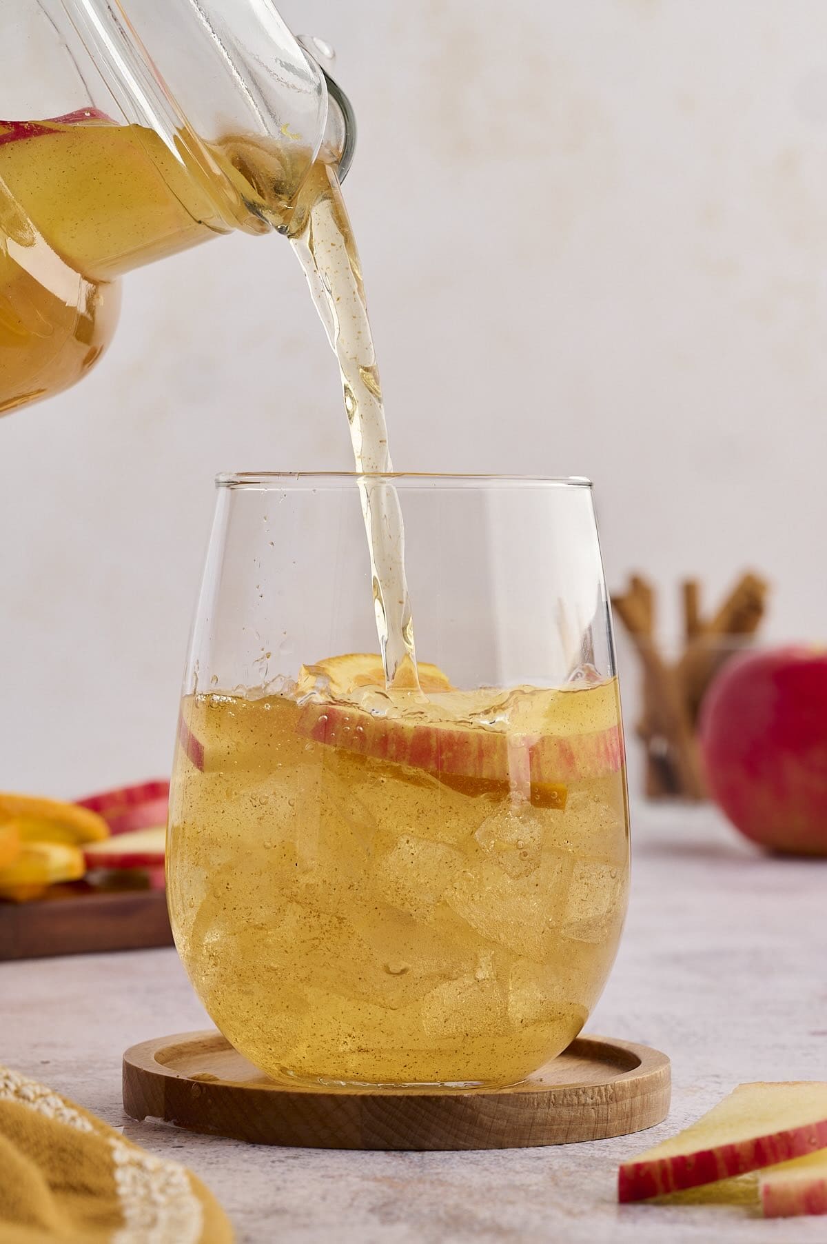 Pouring glasses of apple cider punch.
