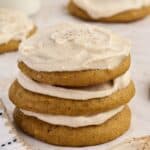 Stack of soft pumpkin cookies with cream cheese icing.