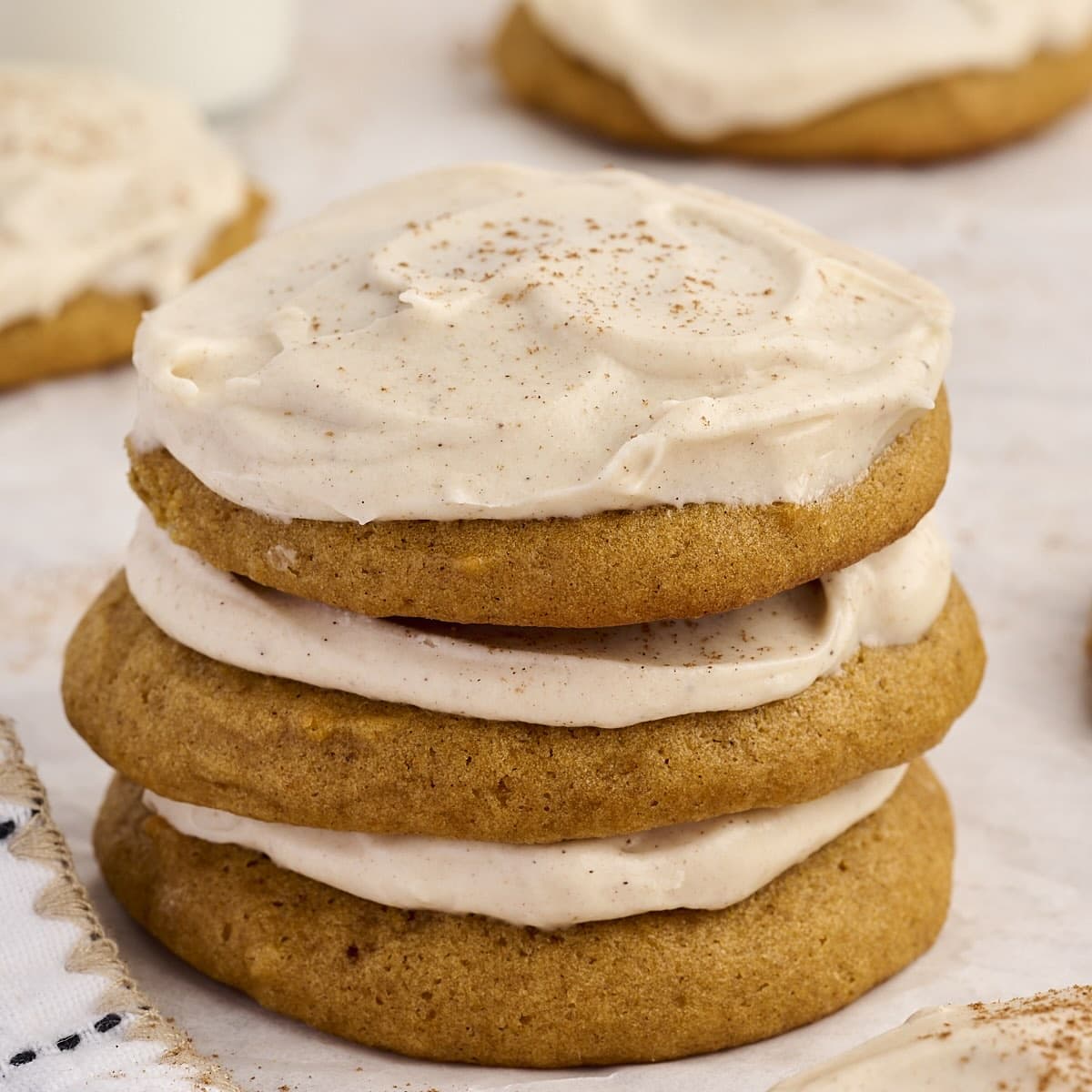 Stack of soft pumpkin cookies with cream cheese icing.