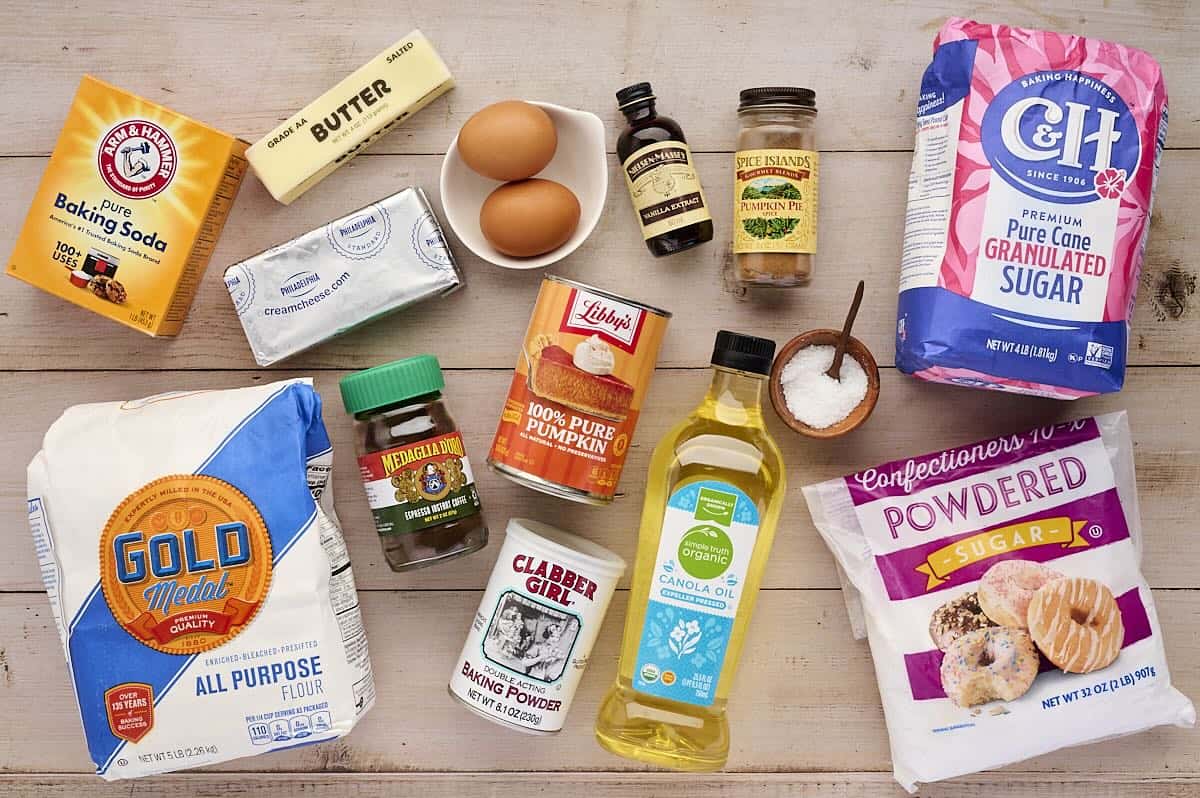 Ingredients to make pumpkin cookies with cream cheese frosting laid on a table.