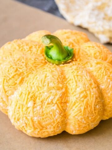 A cheddar ranch cheese ball shaped like a pumpkin.