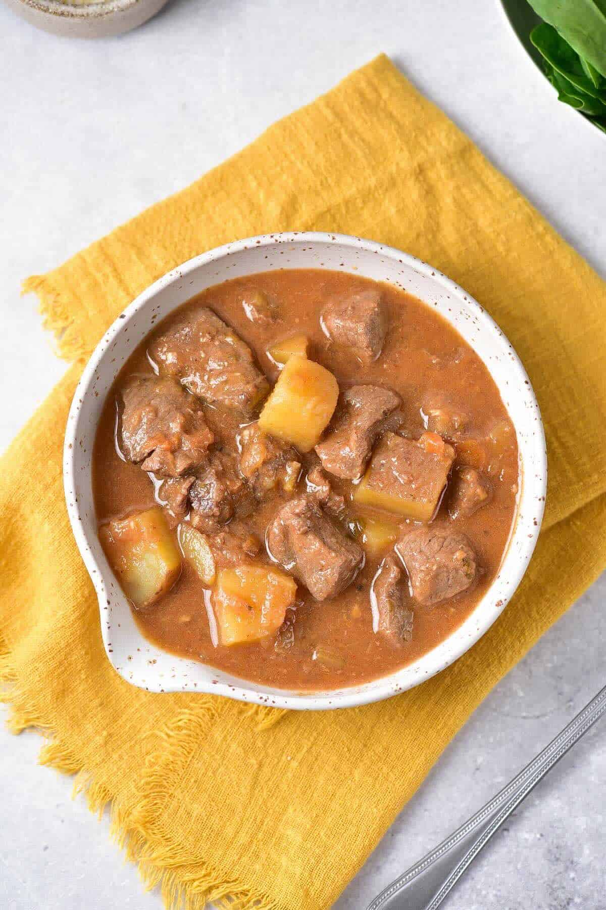Bowl of hearty venison stew with potatoes and carrots.