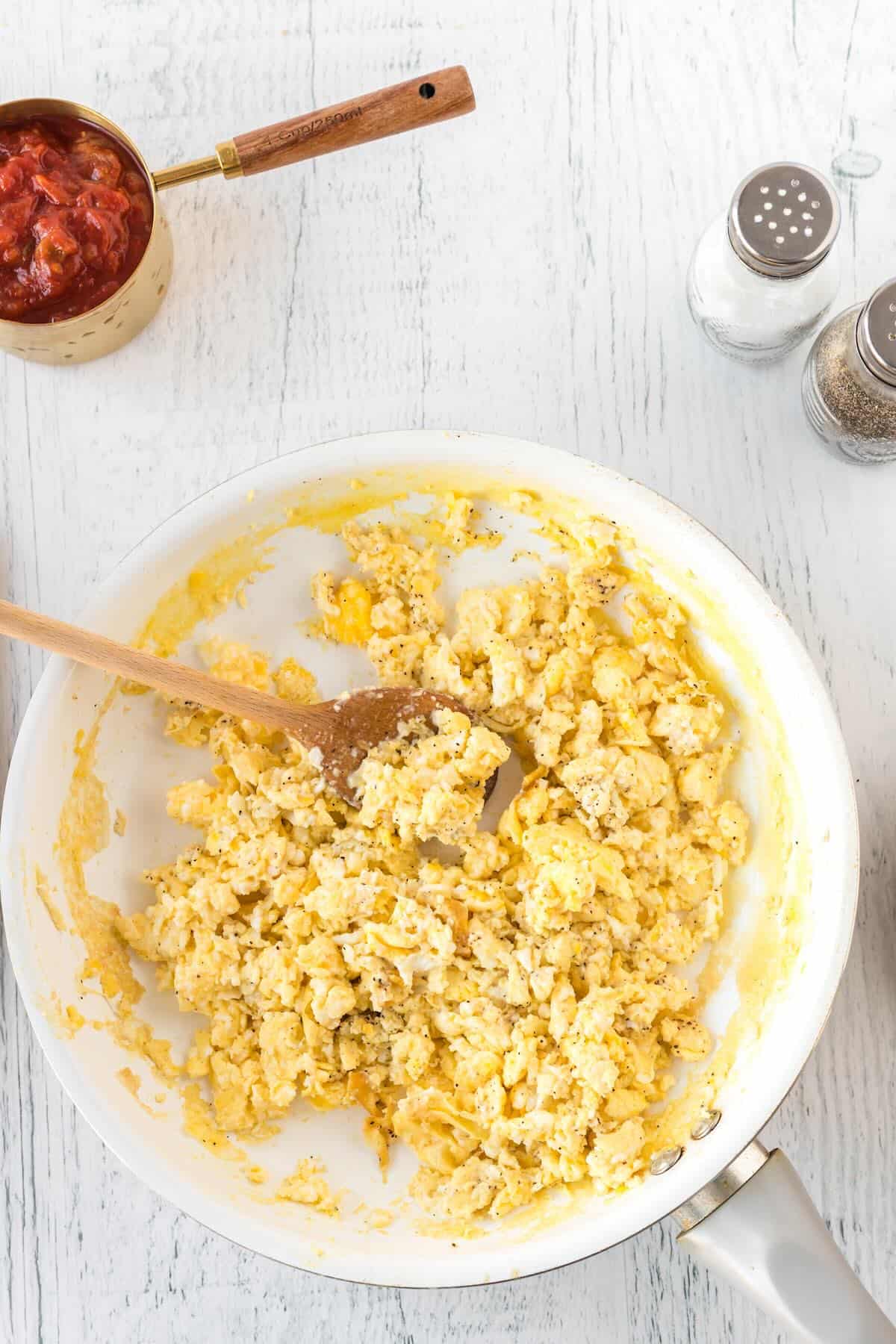 Scrambled eggs cooking in a skillet.