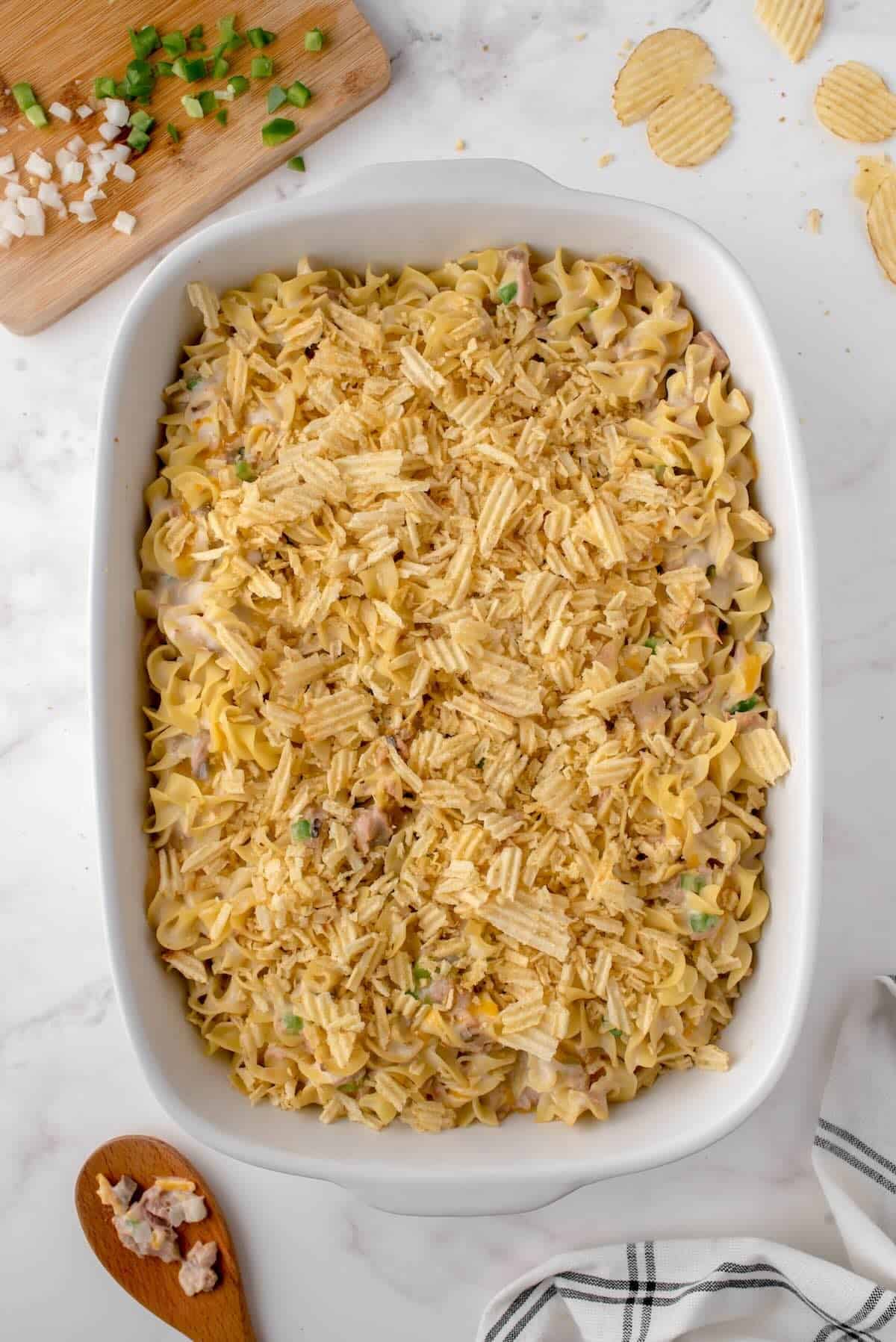 Crushed potato chips sprinkled on top of tuna noodle casserole.