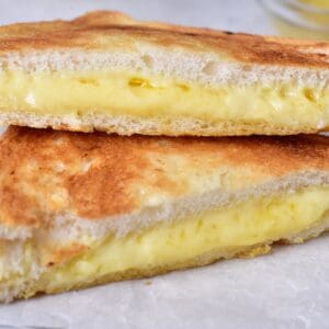 A close up of a gooey grilled cheese sandwich.