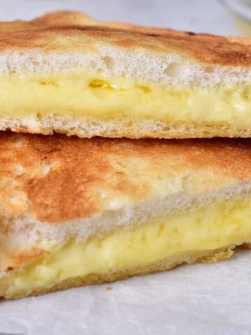 A close up of a gooey grilled cheese sandwich.