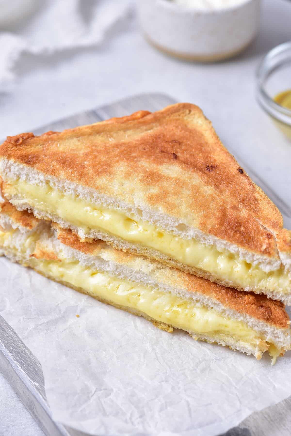 Crispy grilled cheese cooked in the air fryer and cut in half.