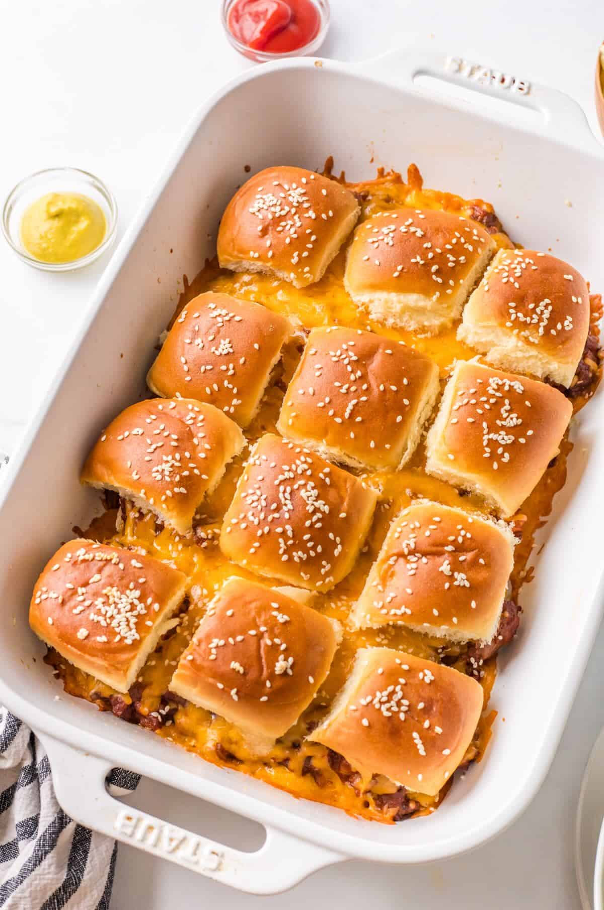 Baked sloppy joe sliders in a casserole pan.