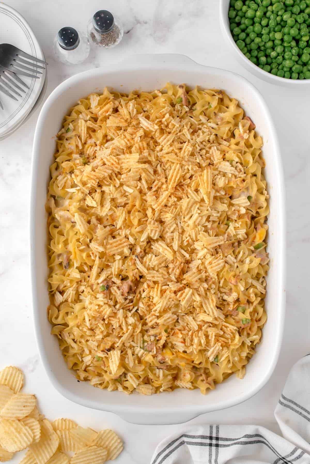 Old-fashioned tuna noodle casserole with golden, crispy potato chip topping fresh from the oven.
