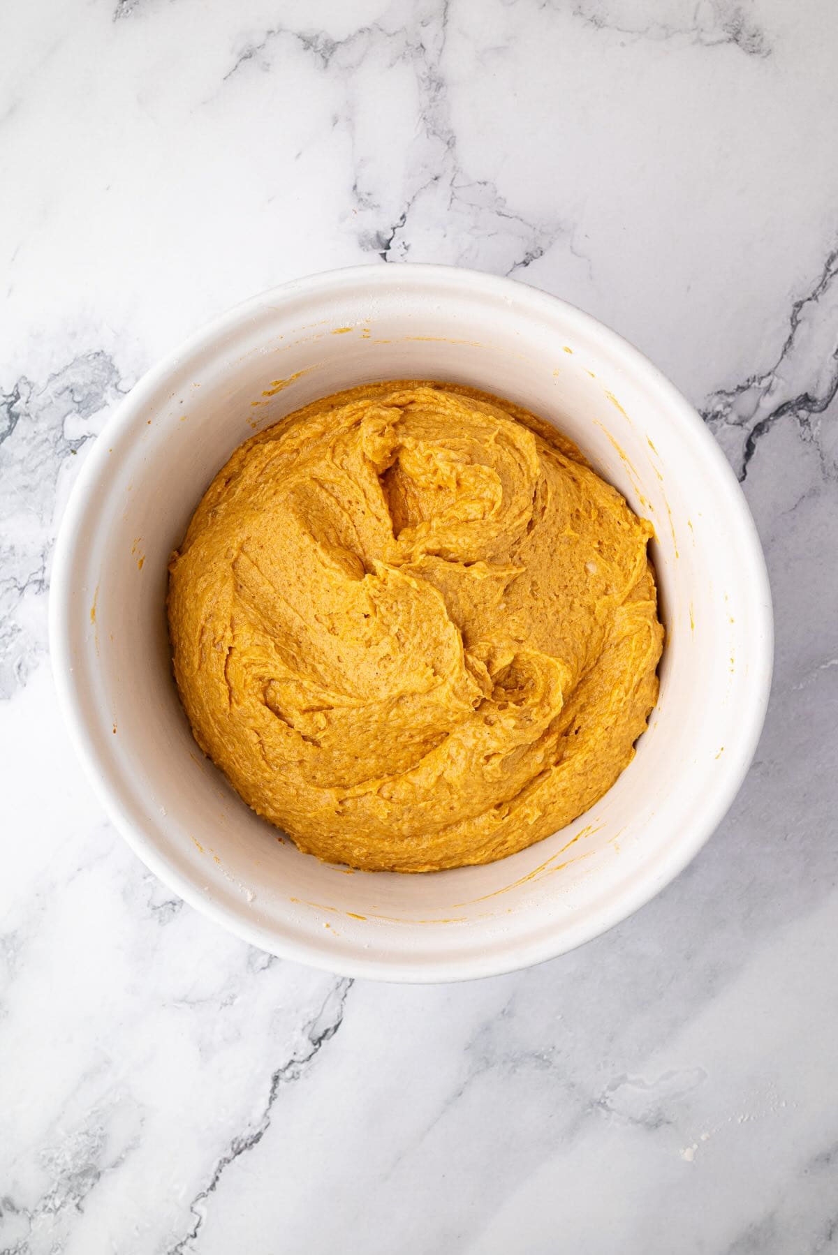 Batter for pumpkin banana bread mixed in a bowl.