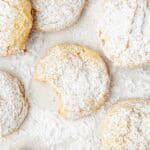 A tray of cookies with a bite taken out of one.