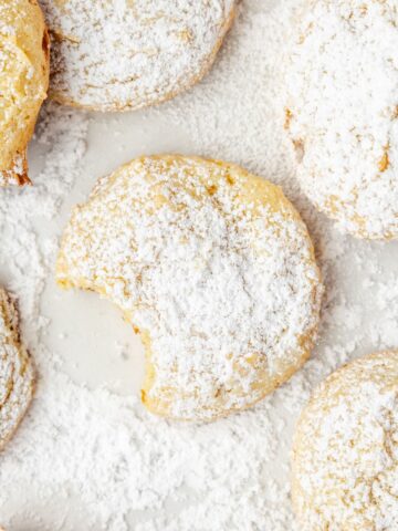 A tray of cookies with a bite taken out of one.