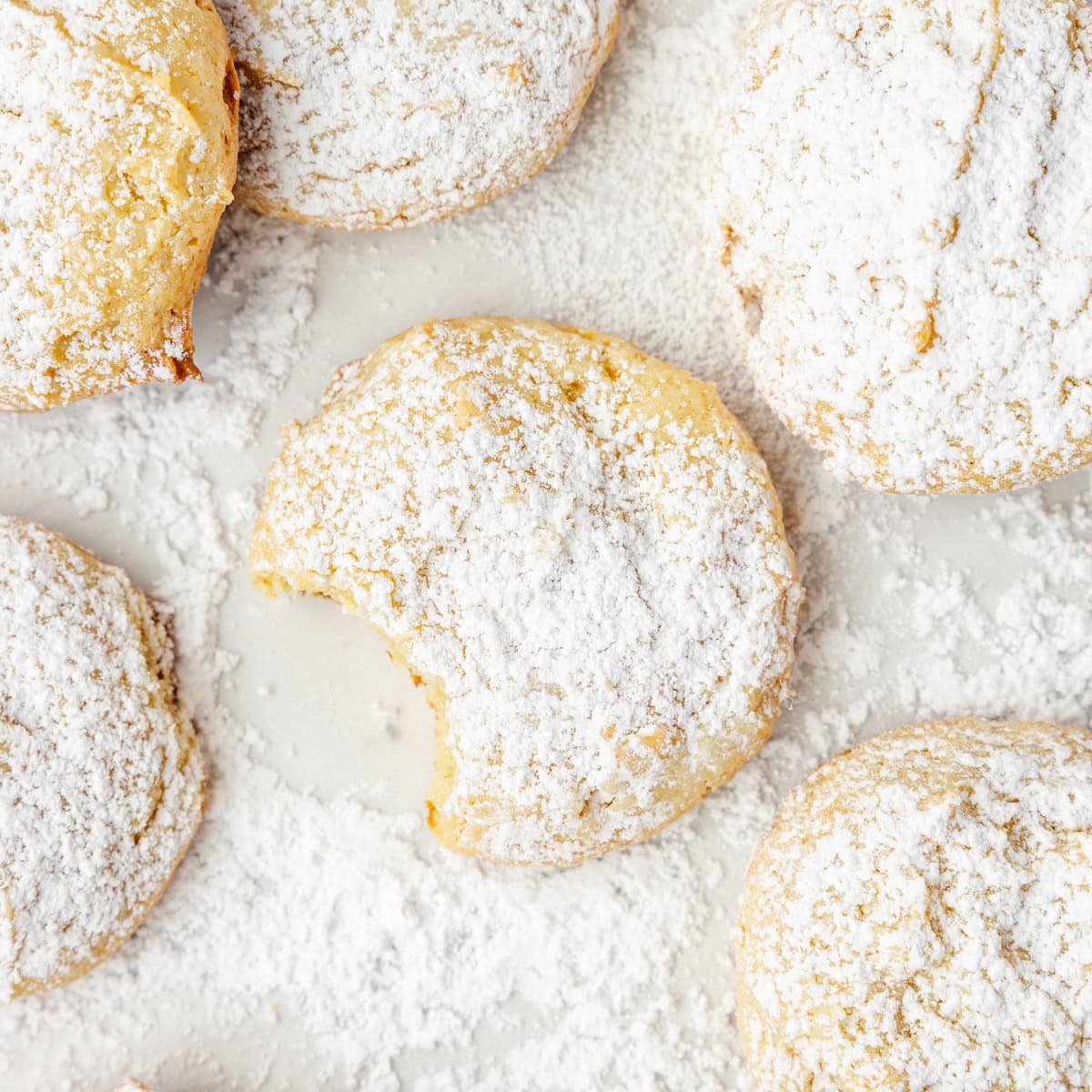 A tray of cookies with a bite taken out of one.