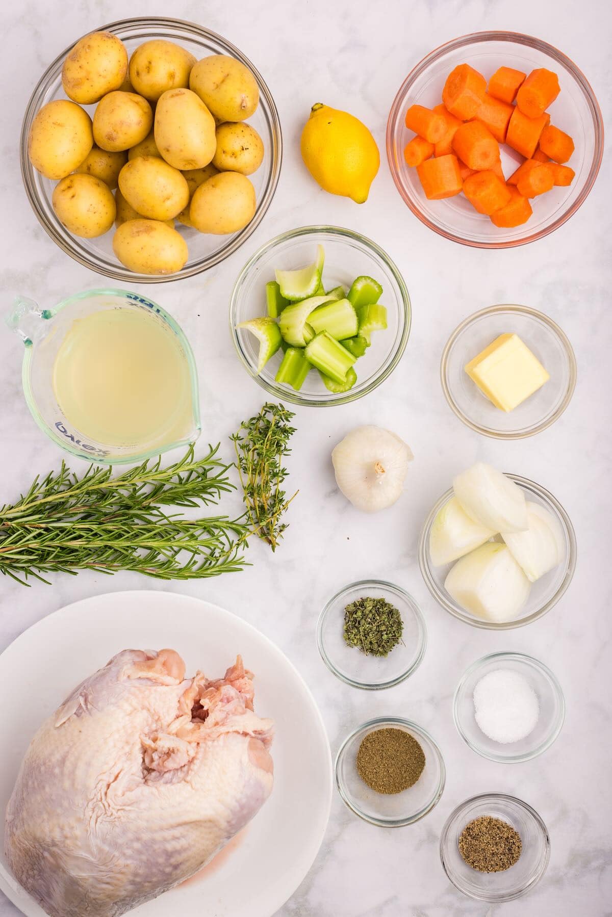 Ingredients to make a bone-in turkey breast with herbed butter laid out on a countertop.