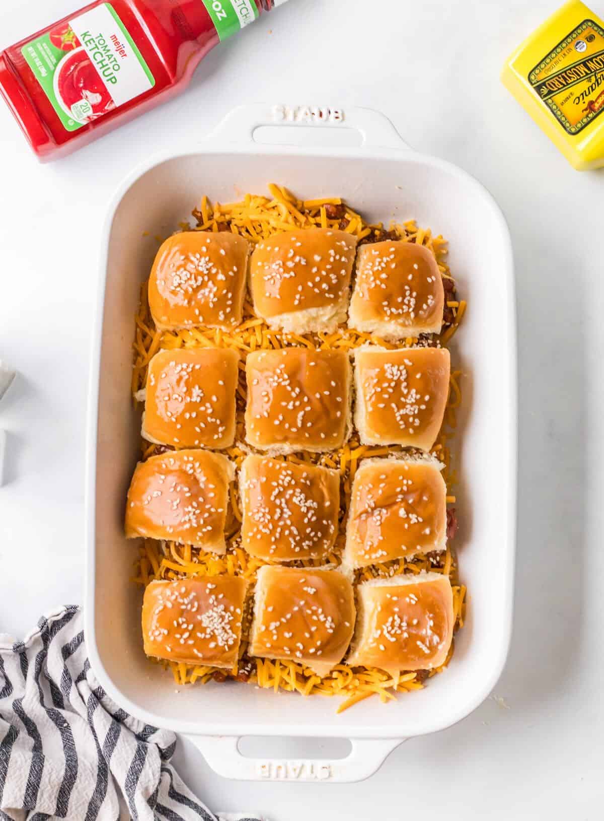 Ground beef sloppy joes on slider buns before baking.