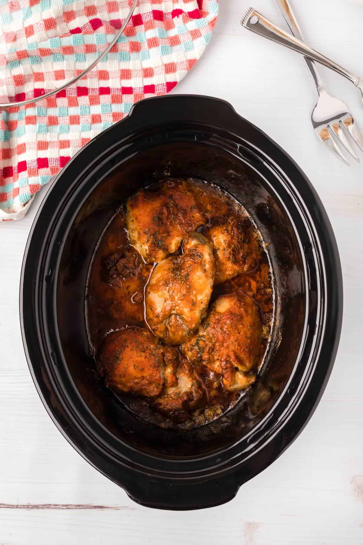 Fully cooked chicken breasts in crock pot ready to shred.