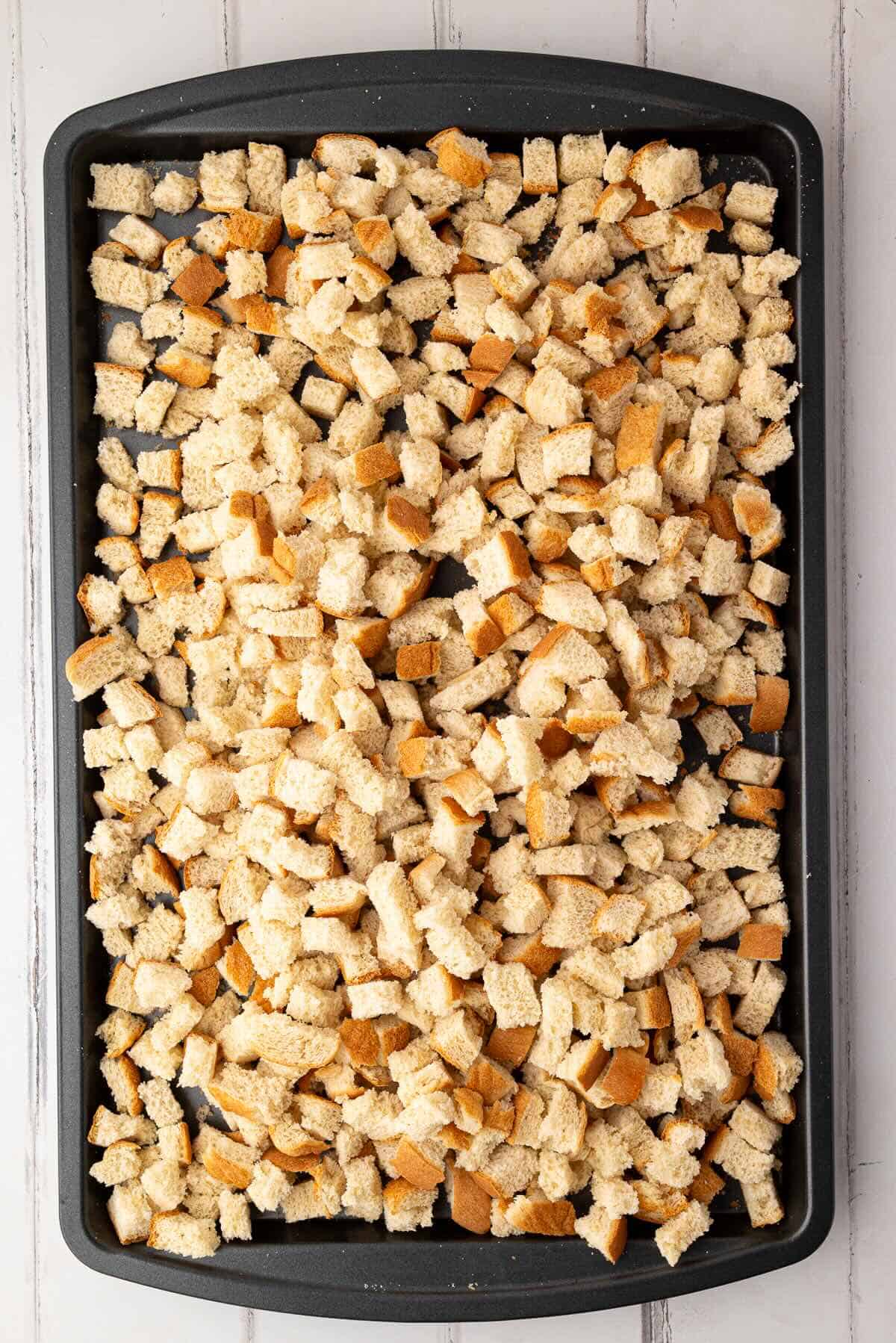 Cubed white bread drying on a 
baking sheet for stuffing croutons.