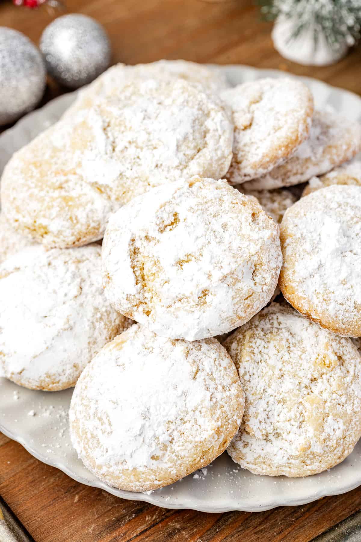 A holiday cookie plate featuring cream cheese cookies dusted with sugar.