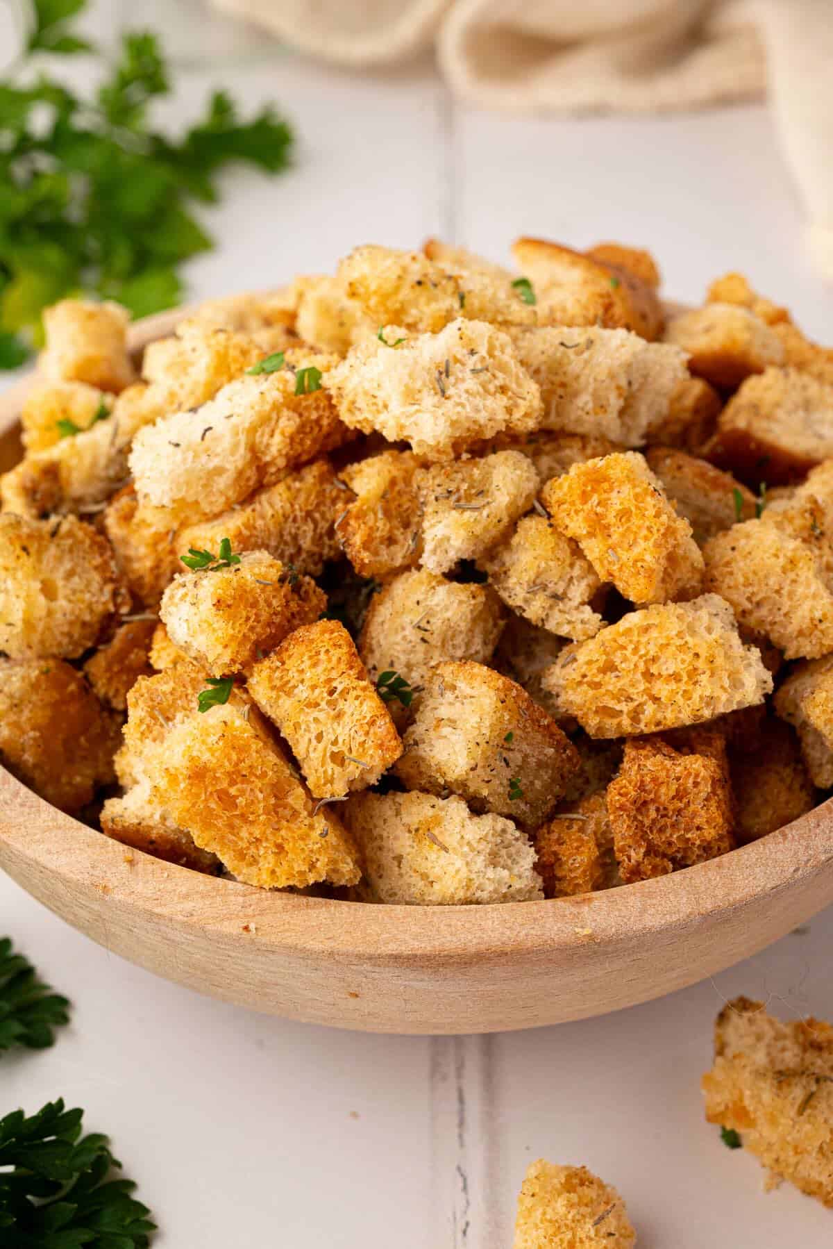 Freshly baked stuffing croutons in a bowl.
