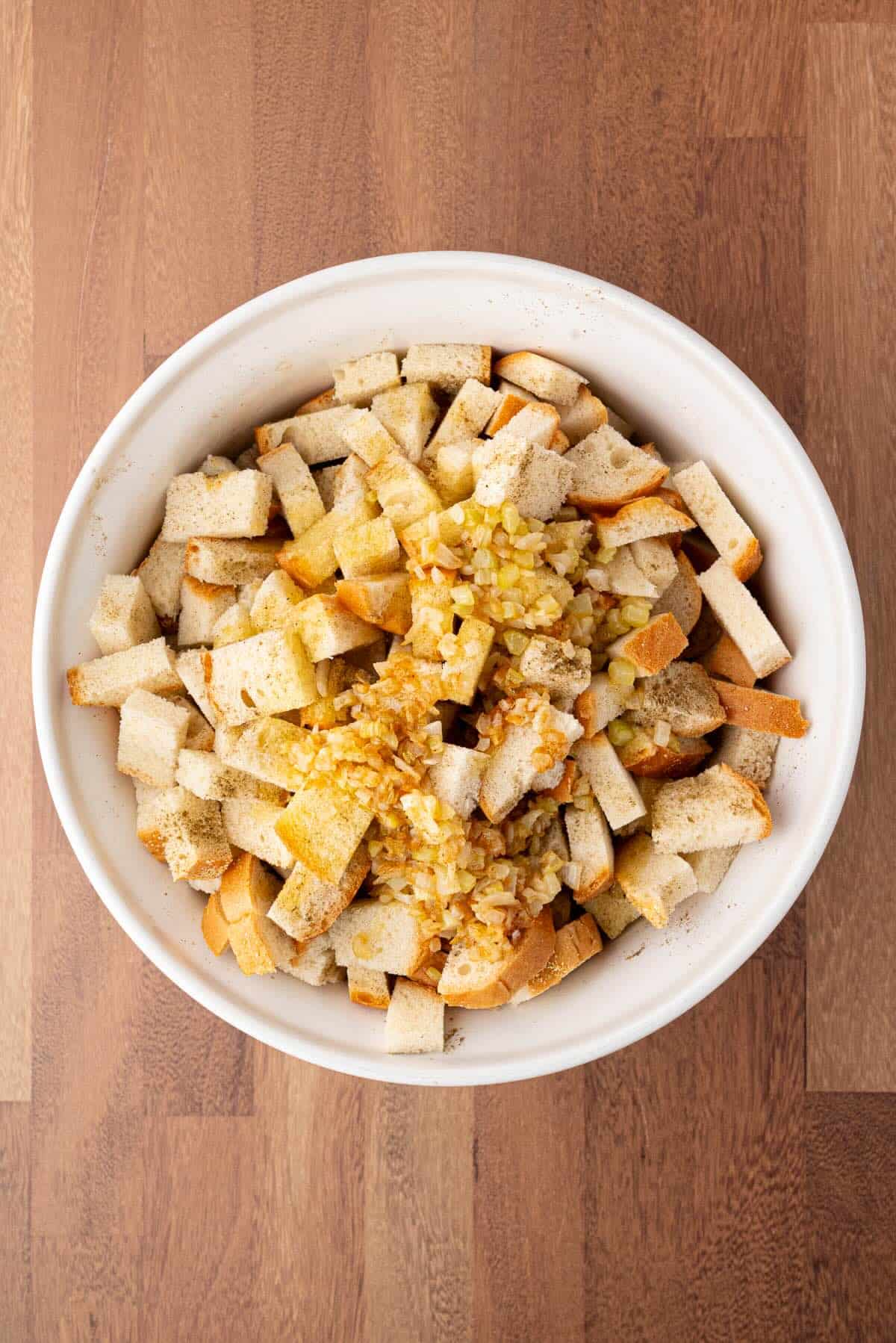 Seasoned stuffing cubes topped with butter and sauteed vegetables.