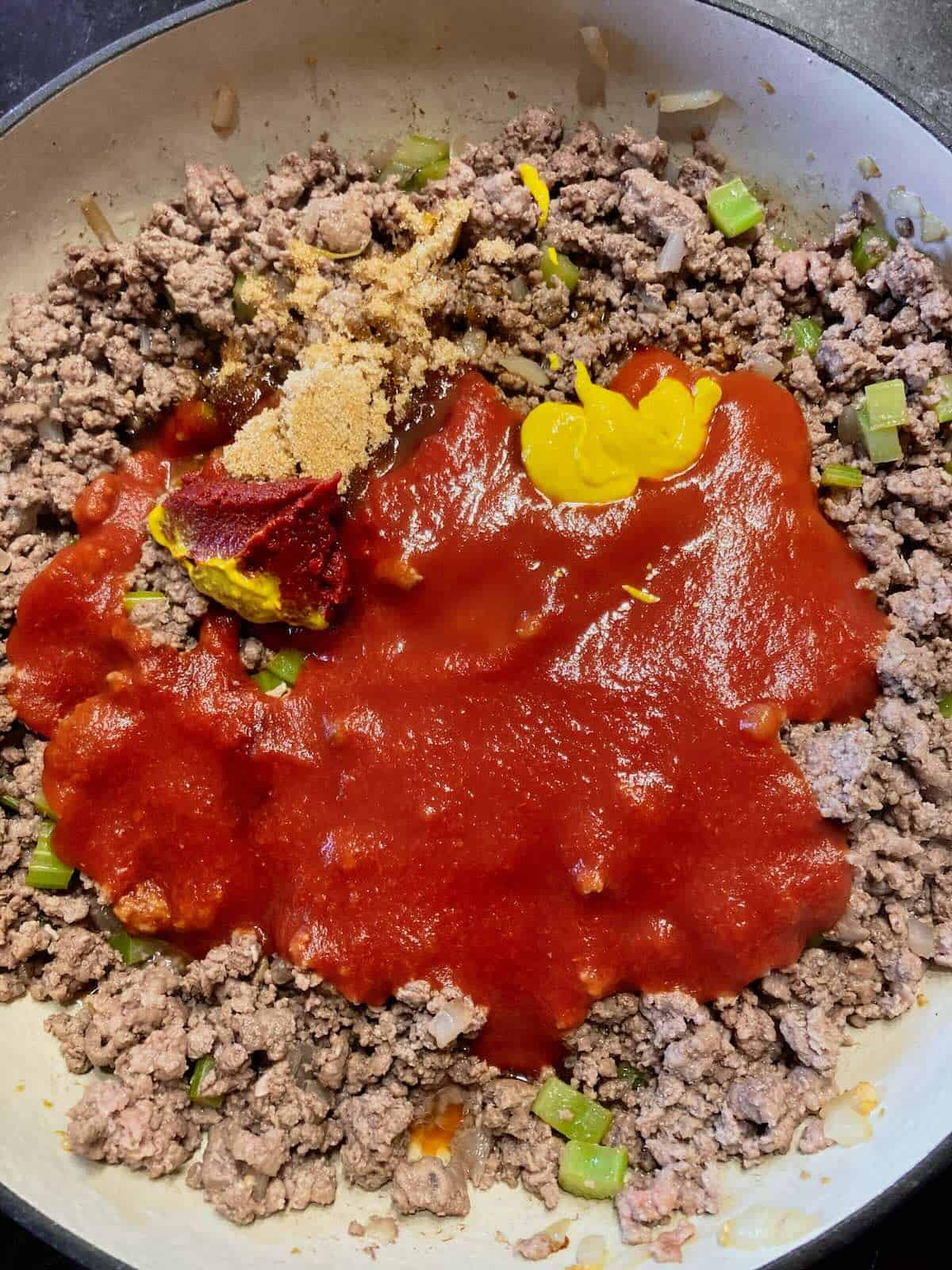 Tomato sauce, ketchup, vinegar, Worcestershire, and brown sugar stirred into the meat mixture.