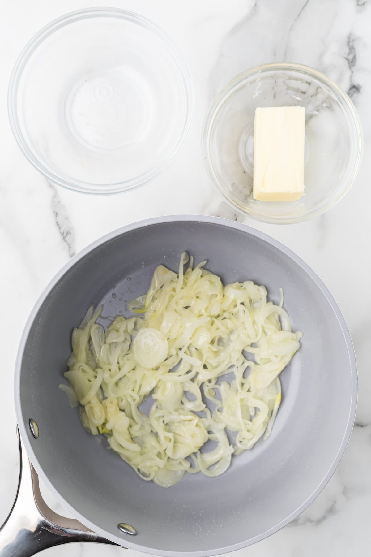 Onions sauteed in butter in a saucepan.