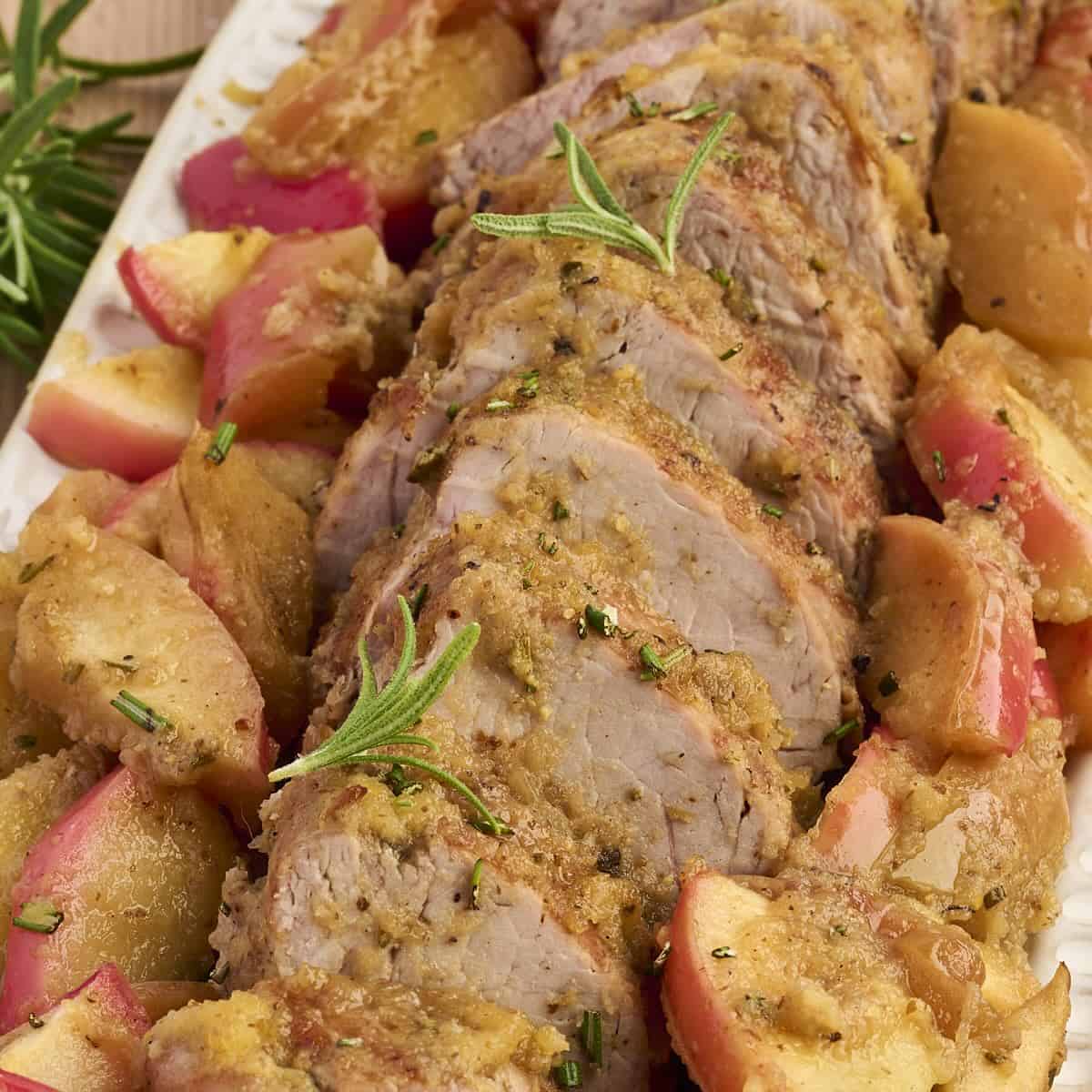 Slices of honey-glazed pork tenderloin served with roasted apples and pan sauce.