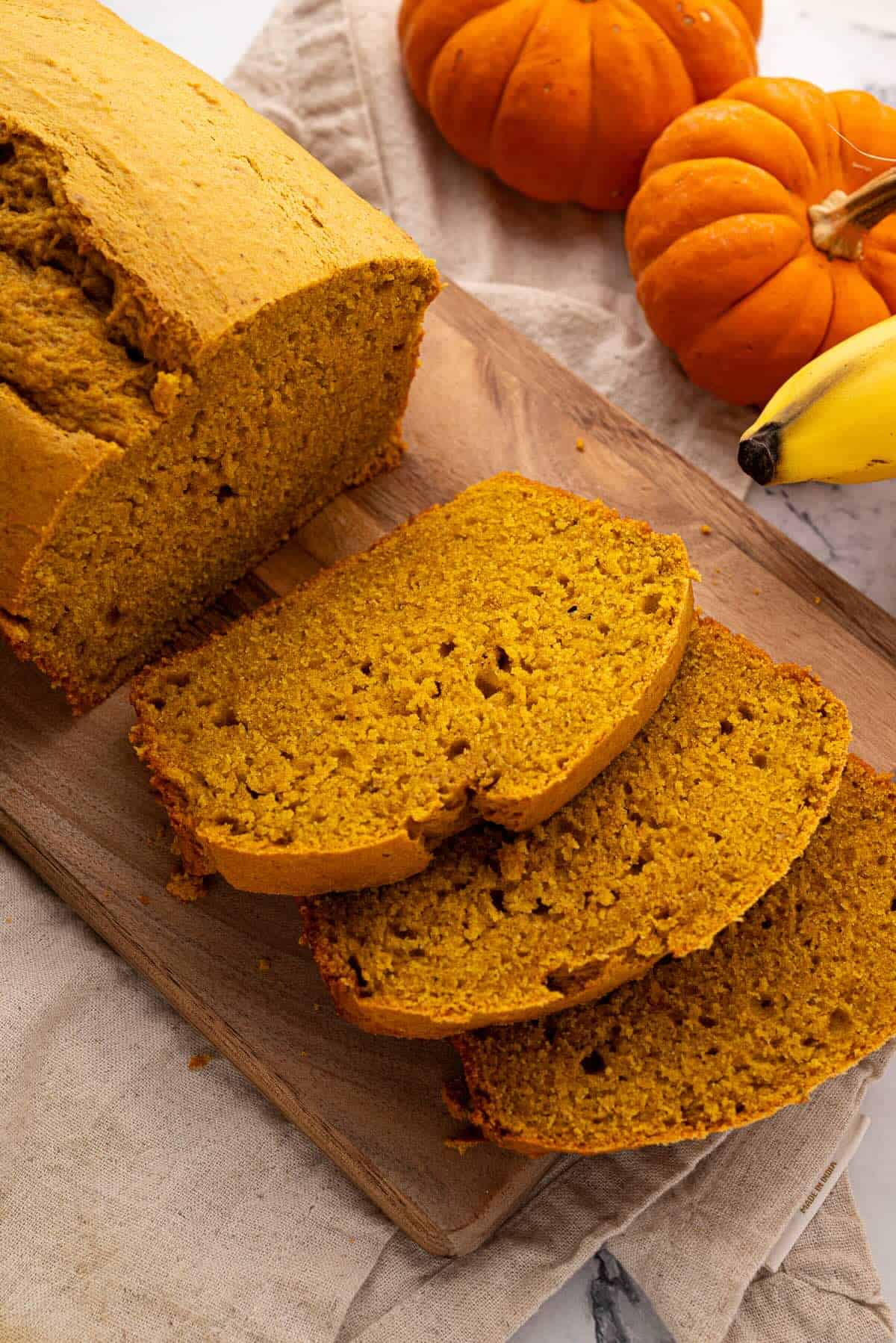 Moist pumpkin banana bread slices showing soft texture and golden color.