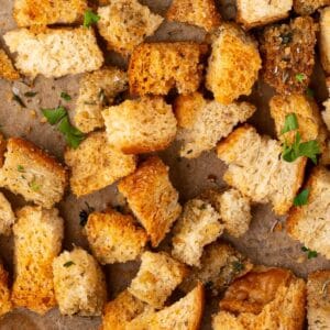 Seasoned stuffing croutons on a sheet pan.