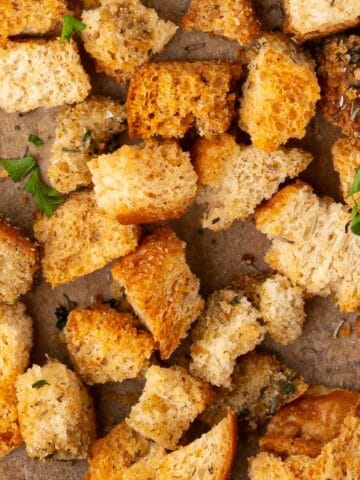 Seasoned stuffing croutons on a sheet pan.