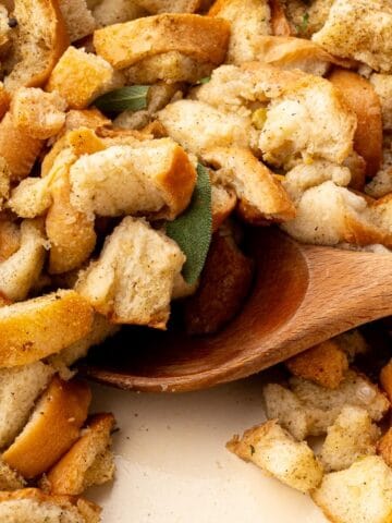Close-up of classic Thanksgiving stuffing showing toasted bread cubes and tender vegetables.