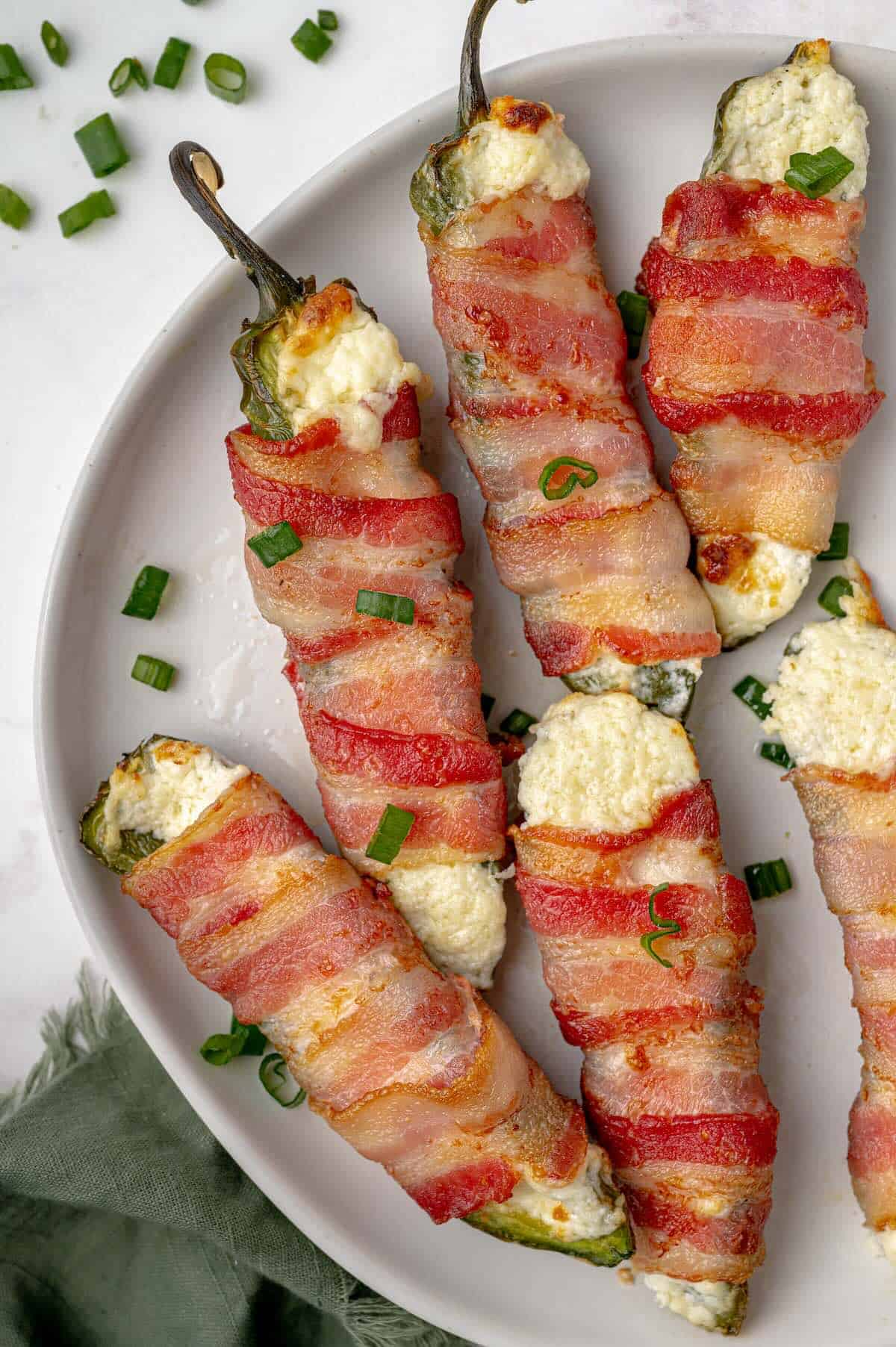 Bacon-wrapped jalapeño poppers with creamy cheese filling ready to serve.