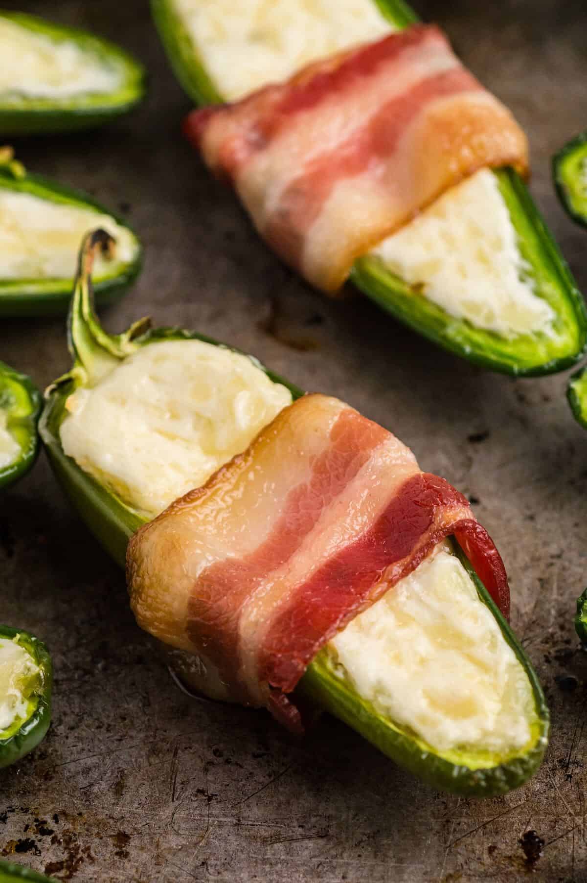 Oven-baked jalapeño poppers with golden bacon and melted cheese.