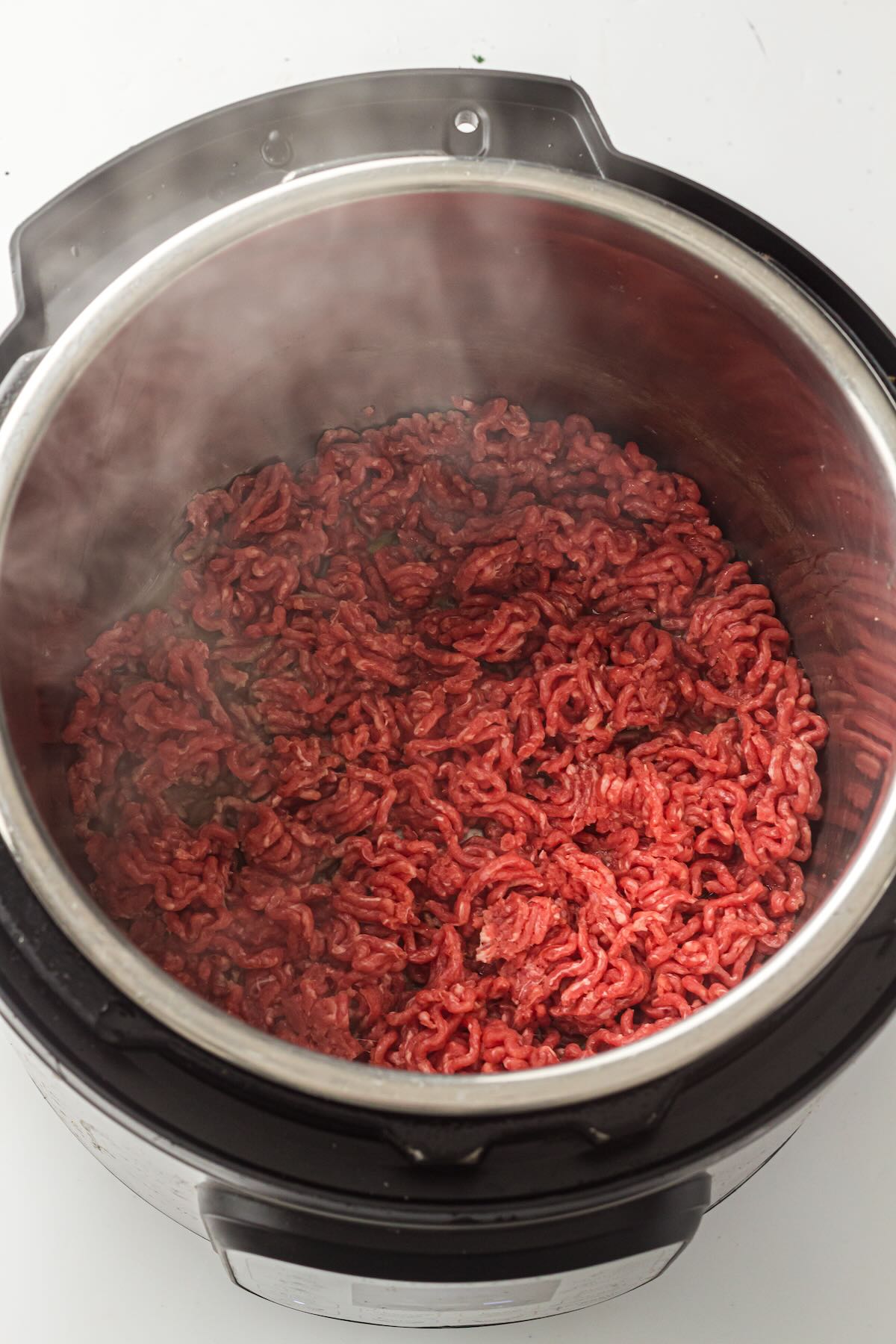 Lean ground beef browning in an Instant Pot.