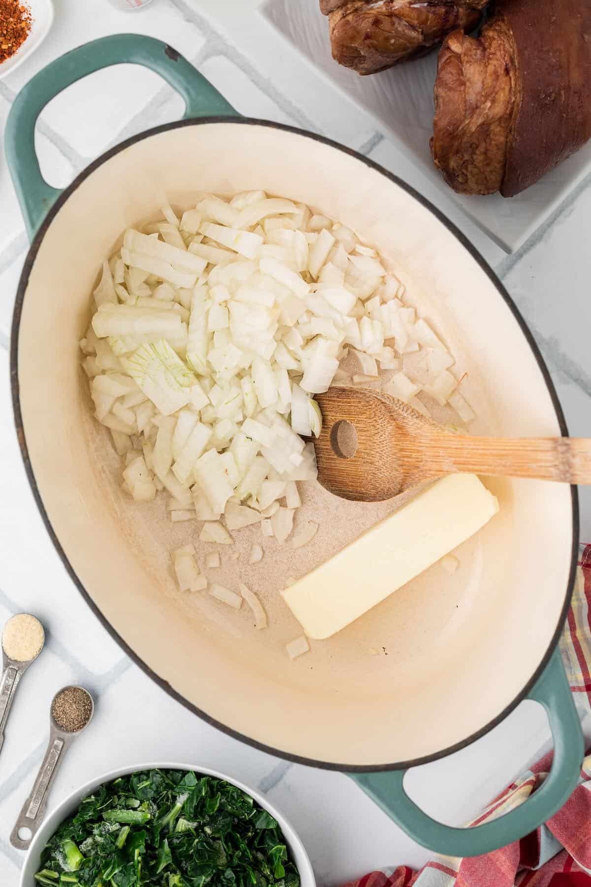 Diced onions and butter in a large pot to start the collard greens.