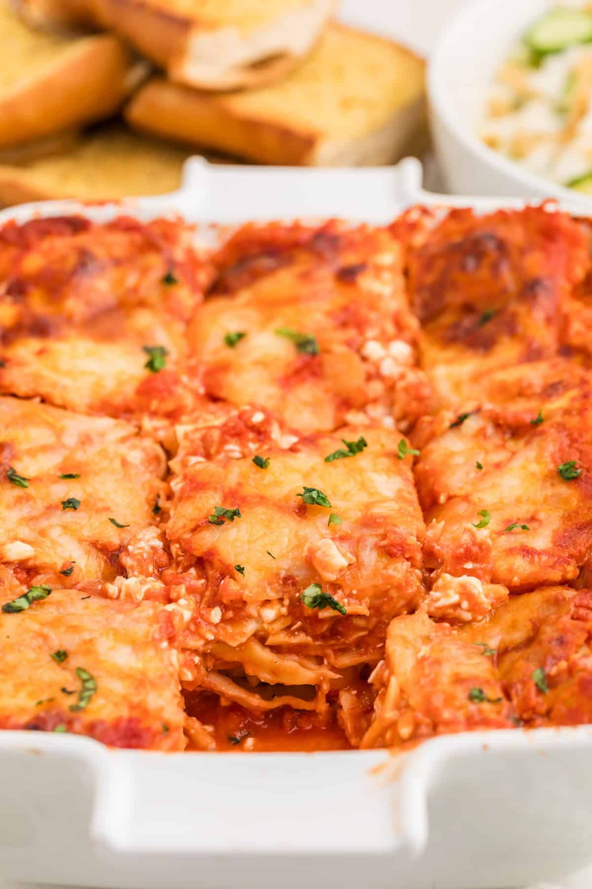 Close-up of perfectly melted mozzarella cheese on top of the baked ravioli lasagna.
