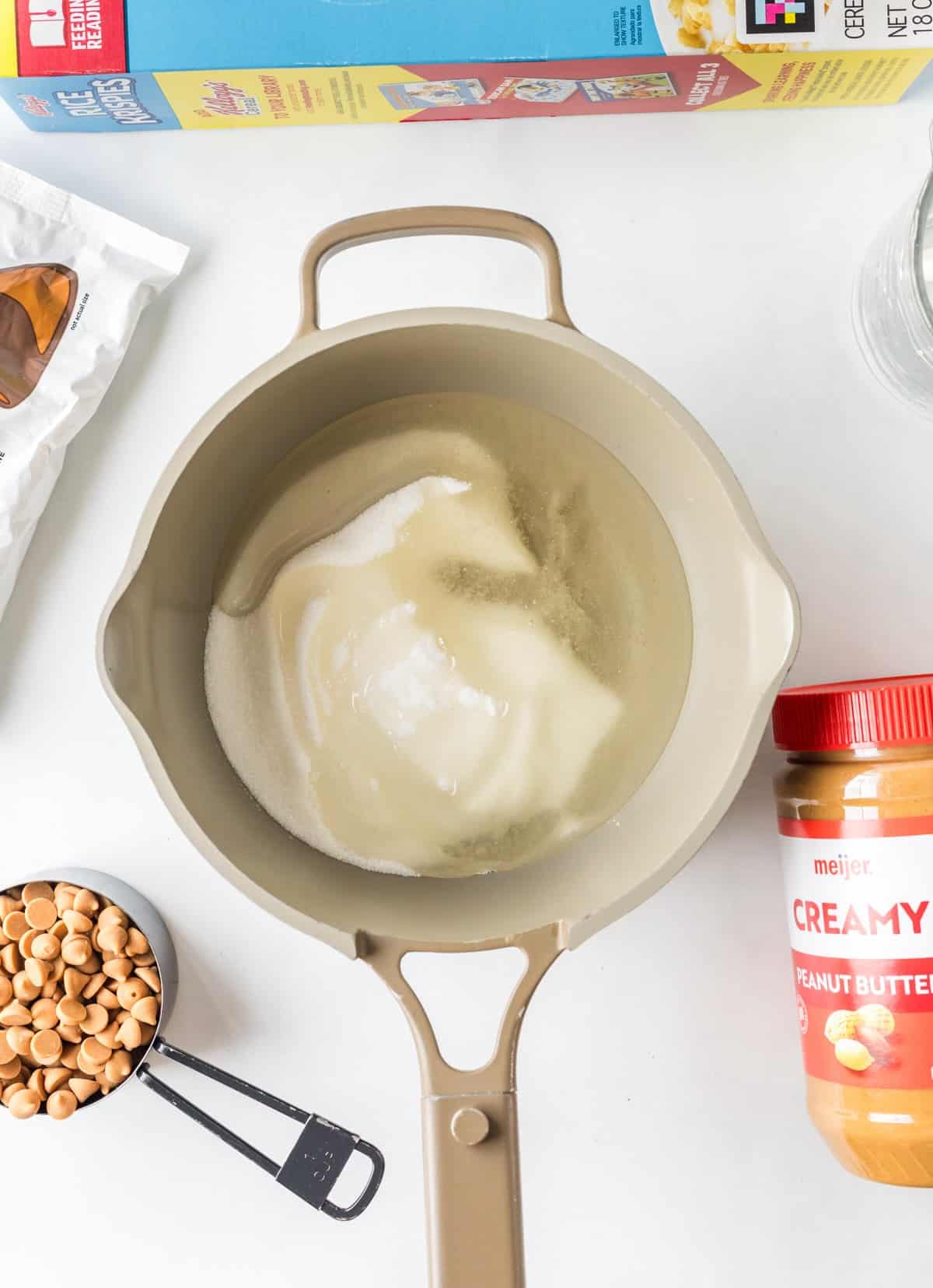 Sugar and corn syrup mixture in saucepan for chewy scotcharoo recipe base