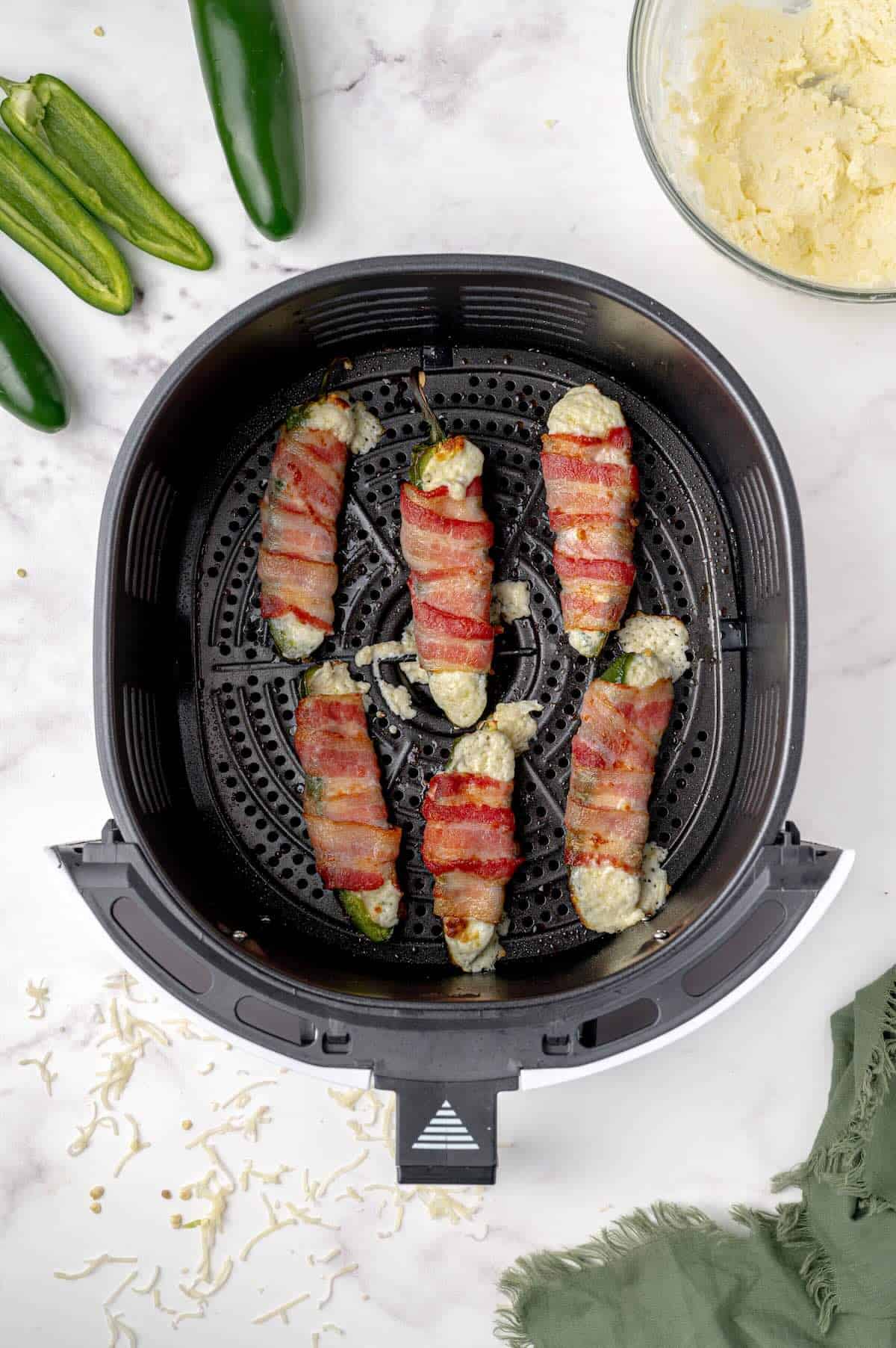 Crispy air fryer jalapeño poppers with gooey cheese filling.