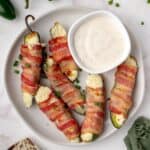 Homemade jalapeño poppers served on a platter with ranch for dipping.
