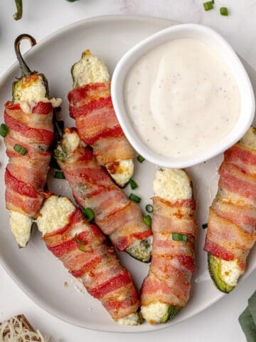 Homemade jalapeño poppers served on a platter with ranch for dipping.