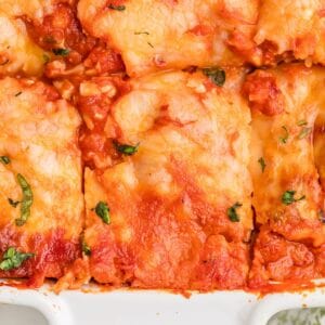 Sliced ravioli lasagna in a casserole pan.