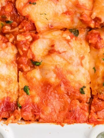 Sliced ravioli lasagna in a casserole pan.