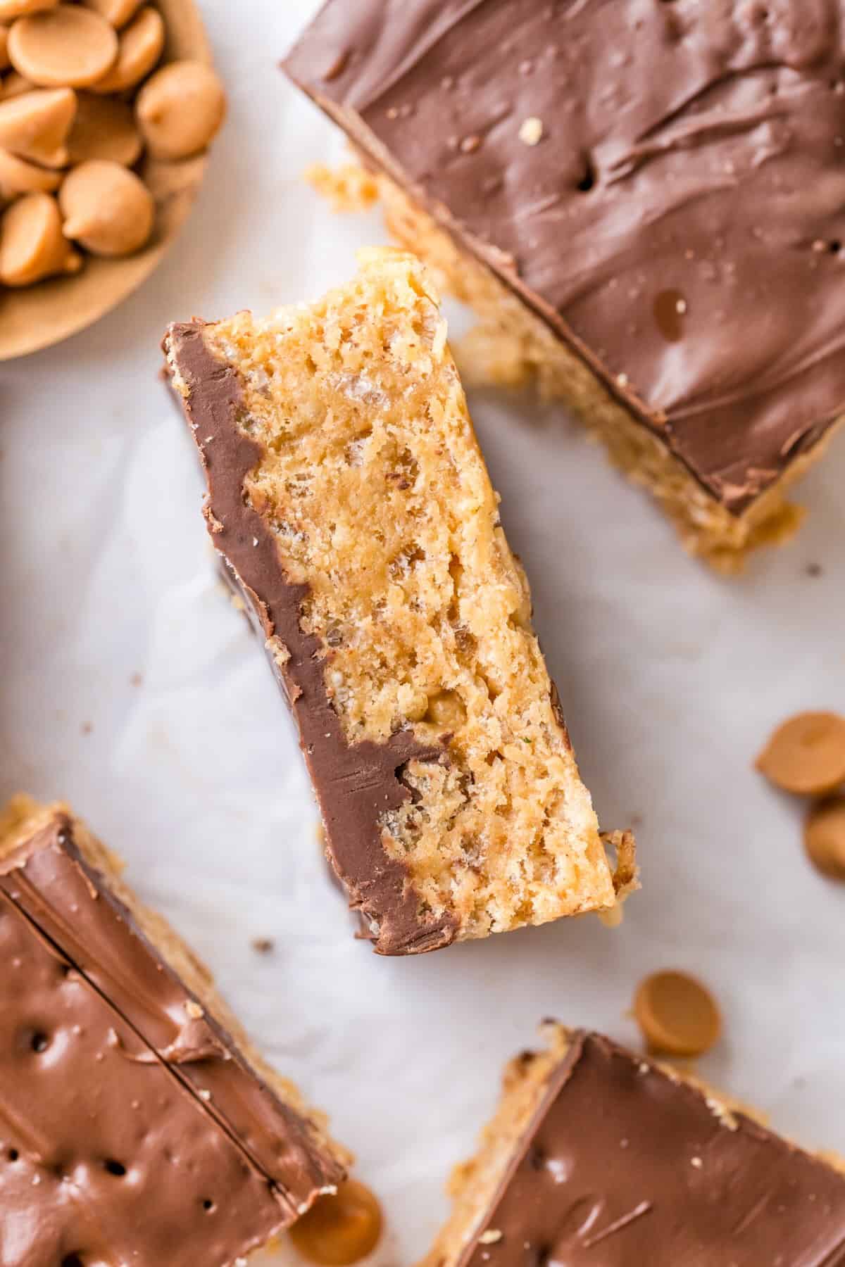 Side view of scotcharoo bars showing chewy layers of peanut butter cereal and chocolate topping.