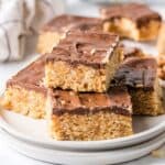A plate of no bake scotcharoo bars, cut into pieces.