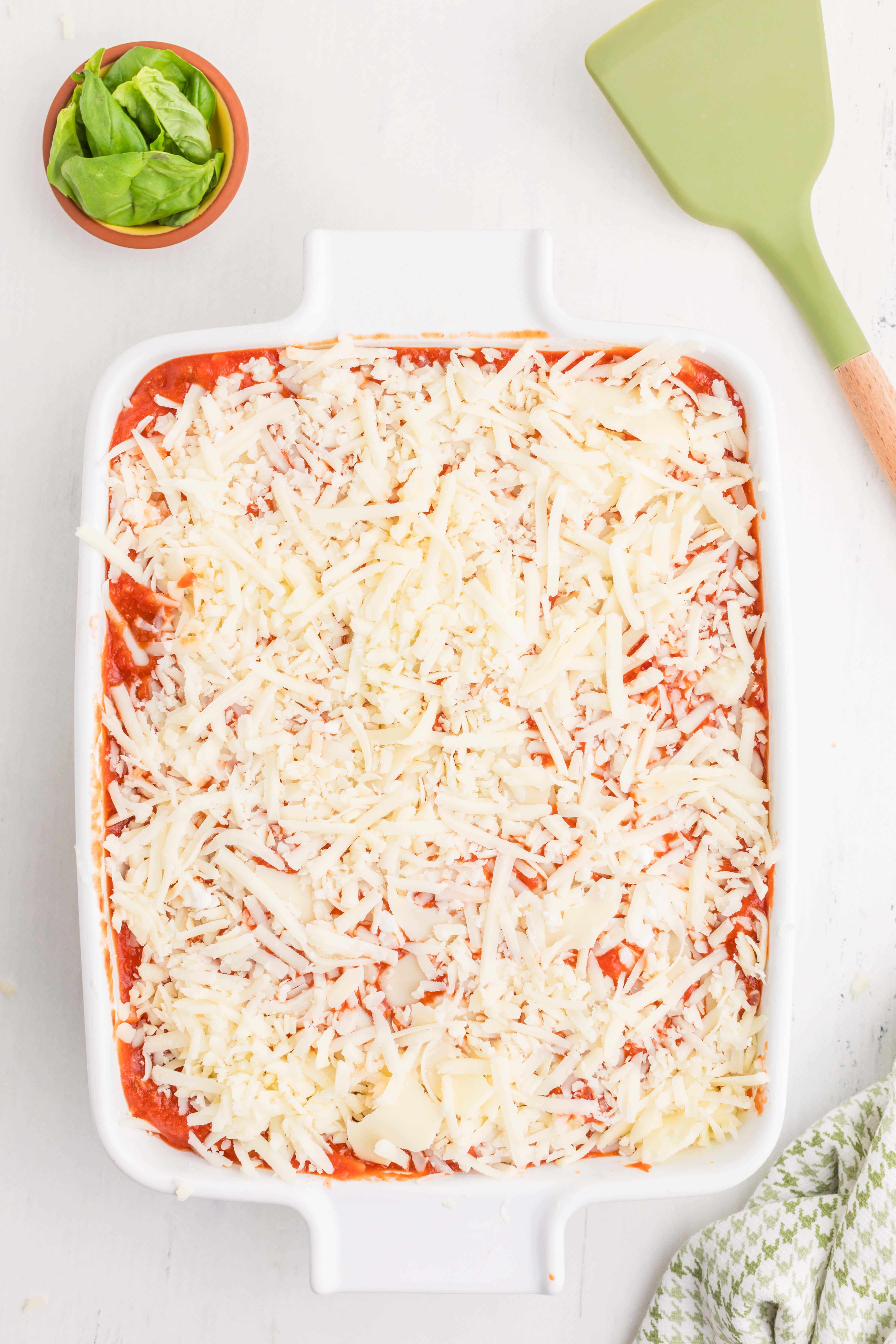 The assembled lazy lasagna with sauce and mozzarella on top, ready to go into the oven.