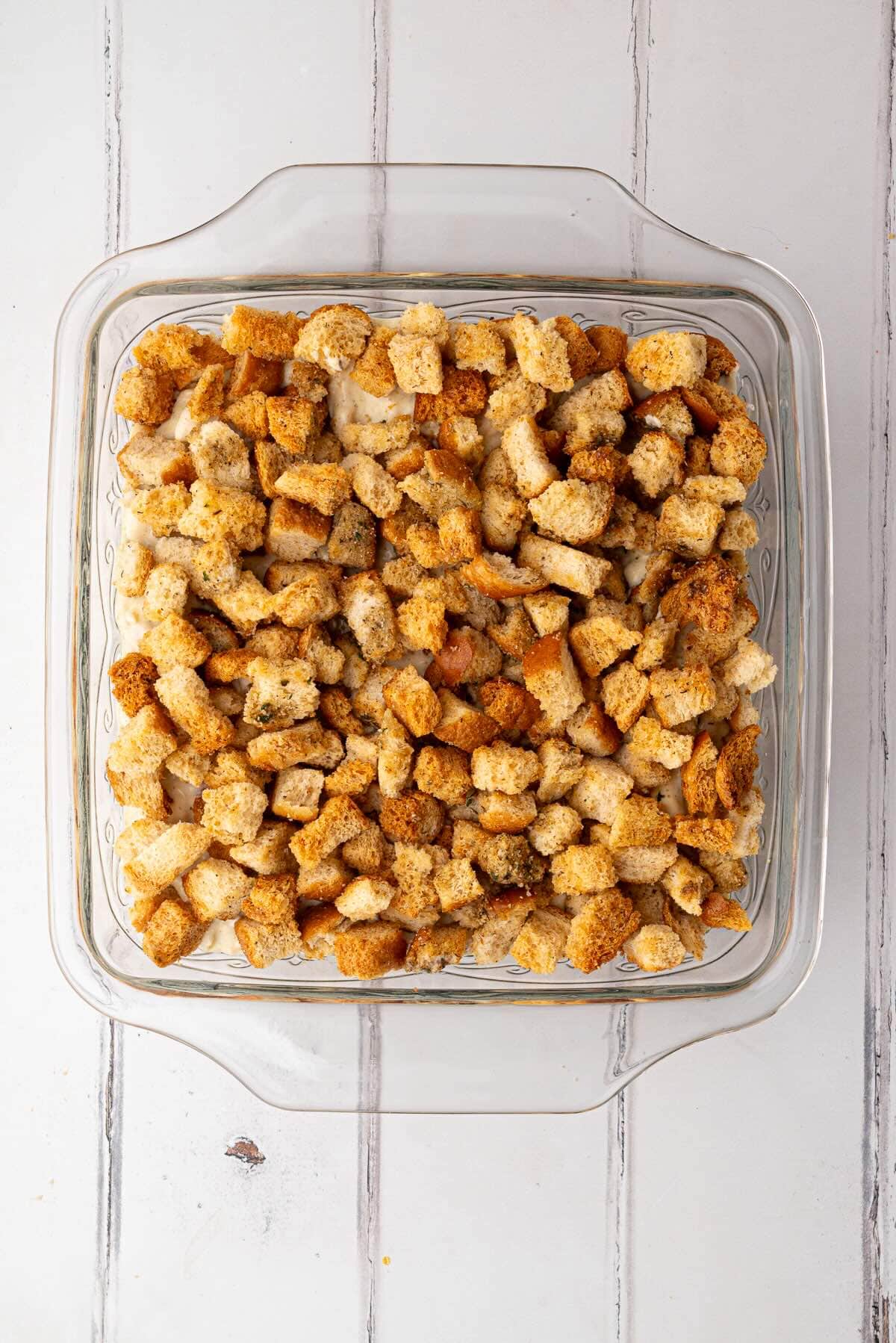 Homemade stuffing croutons layered over the creamy chicken mixture before baking.