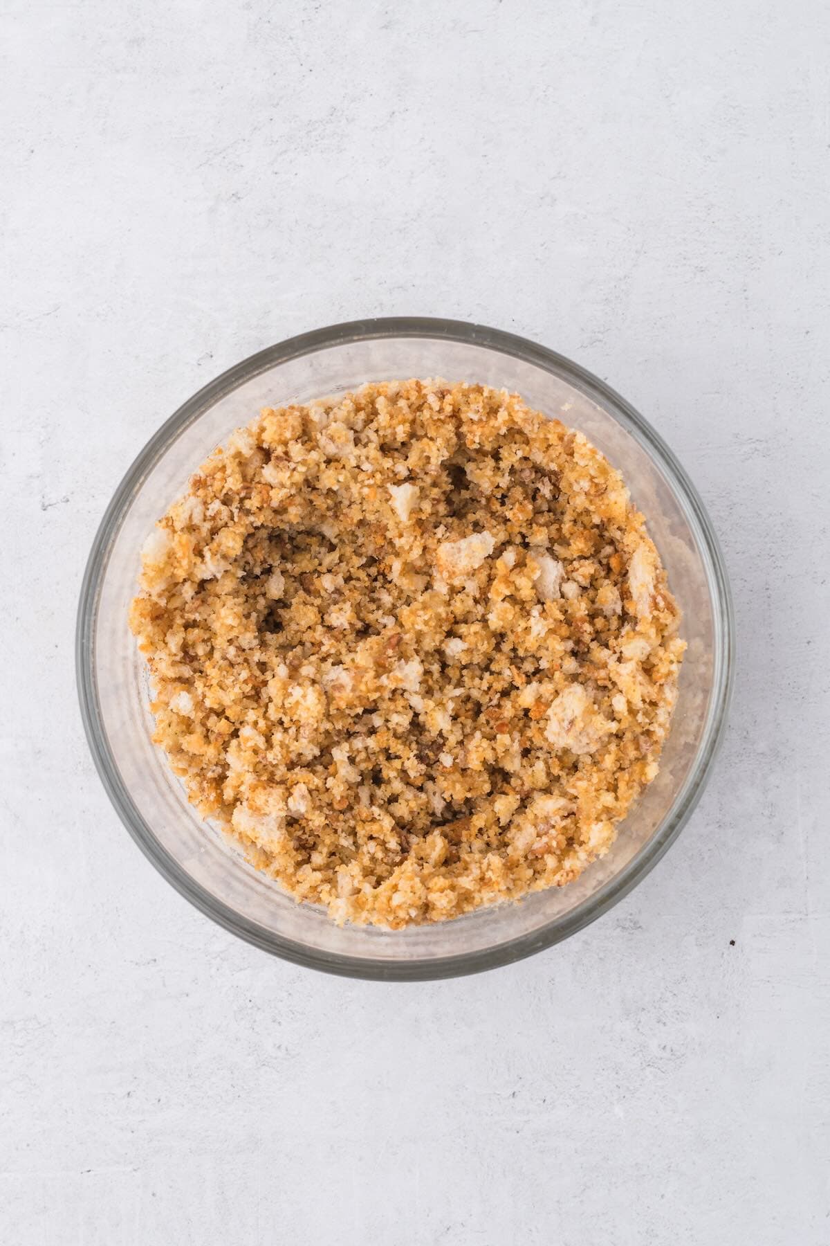 Breadcrumbs and olive oil mixed in a bowl to top the chicken broccoli casserole.