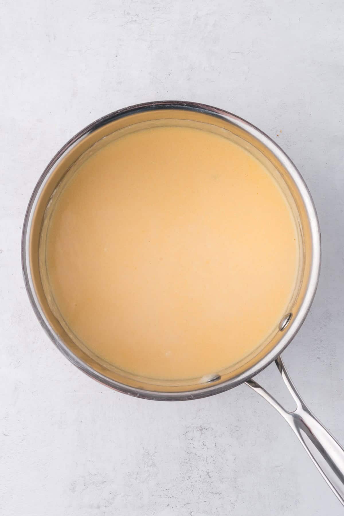 A butter flour mixture turned into a pale blond colored roux for making a cheese sauce.